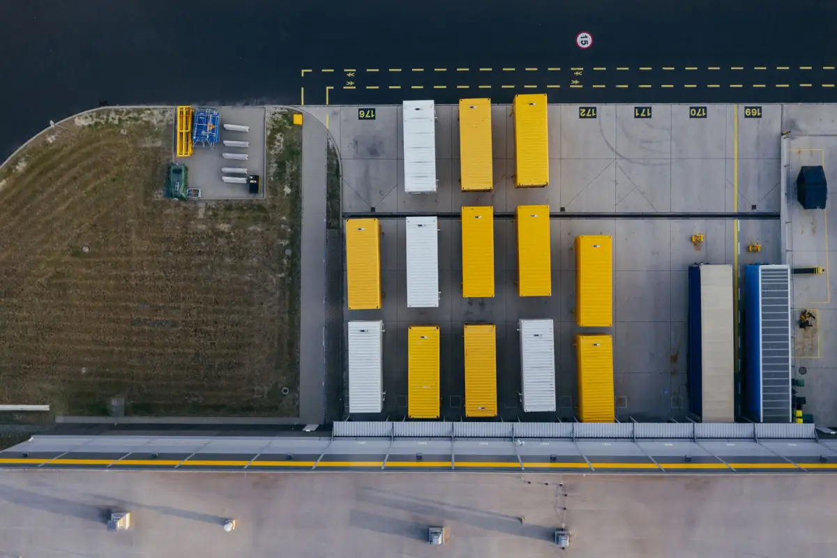 Aerial view of a distribution center with dock doors and a controlled vehicle approach